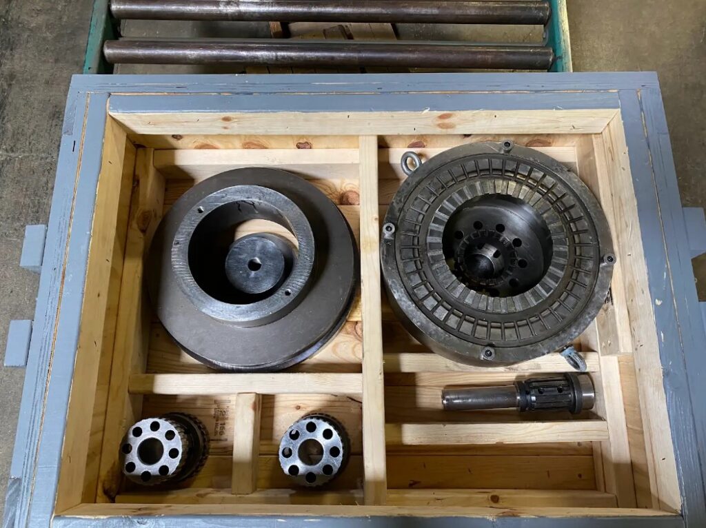 several machined parts packaged in a wooden crate